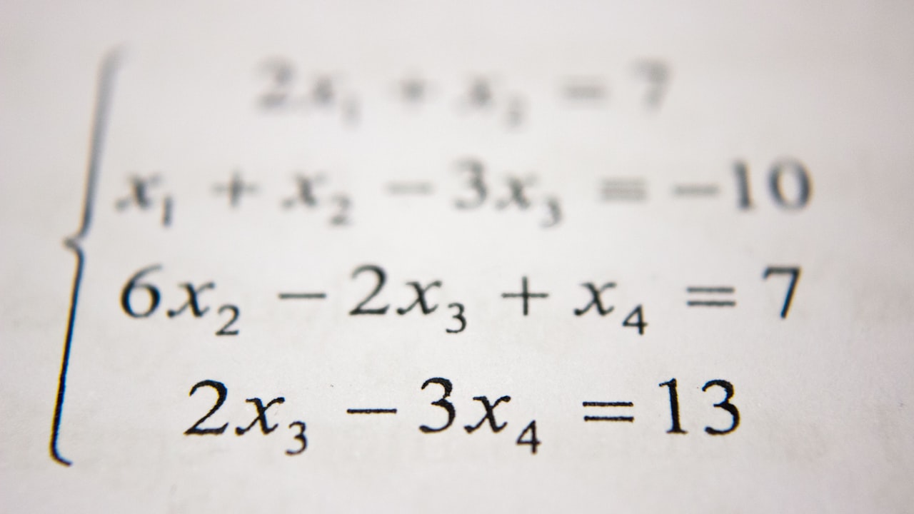 Handwritten math formulas and graphs filling a notebook page