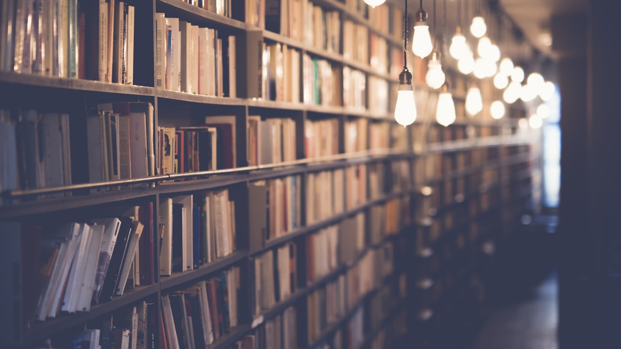 Tall library bookshelves filled with books